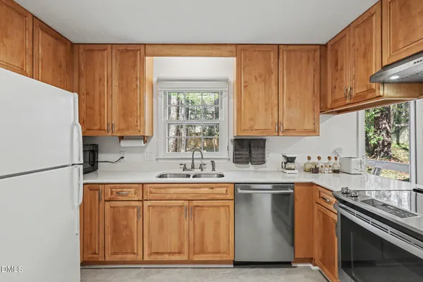 a kitchen with appliances cabinets and a sink