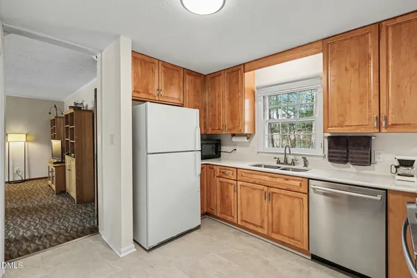 a kitchen with appliances a sink and a window