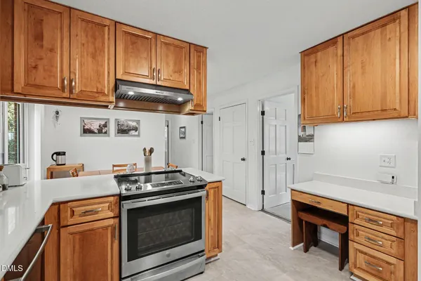 a kitchen with stainless steel appliances granite countertop a stove a microwave and cabinets