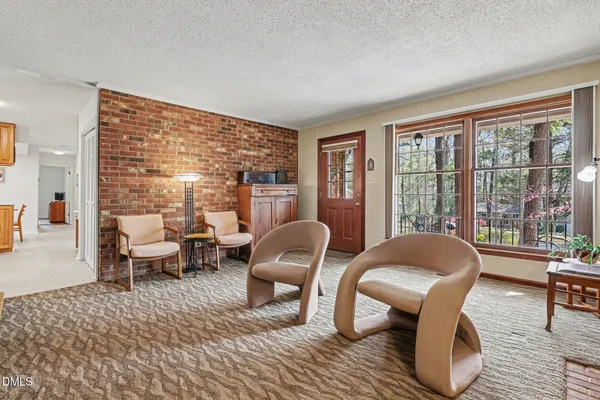 a living room with furniture and a floor to ceiling window
