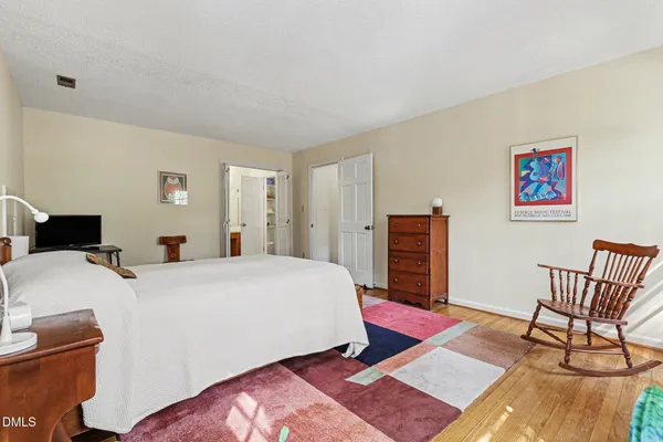 a bedroom with a bed and a dresser in it