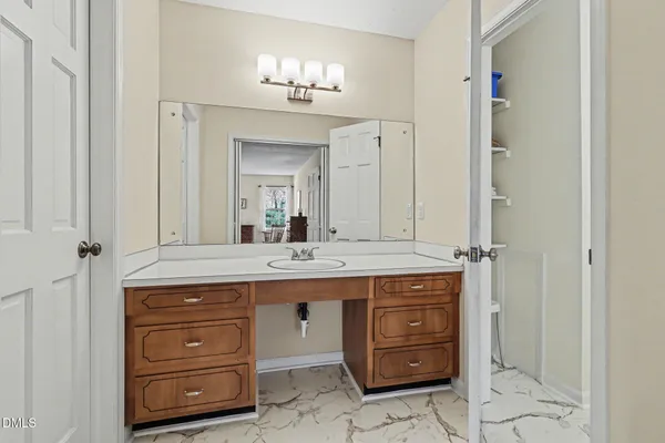a bathroom with a granite countertop sink a mirror and a vanity