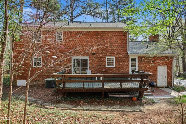 a view of a wooden chairs and bench in the backyard