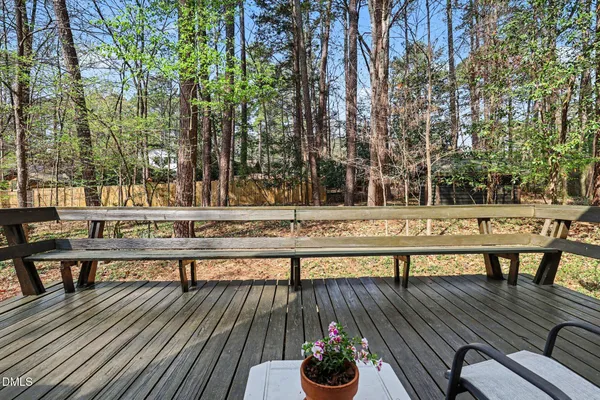 a view of a roof deck with couches and wooden floor