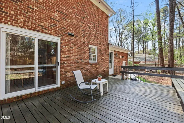 a balcony with wooden floor and outdoor seating