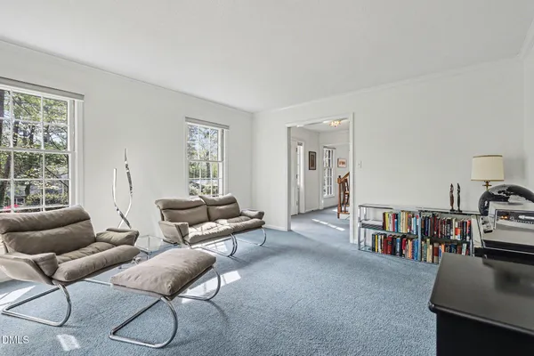 a living room with furniture and a book shelf