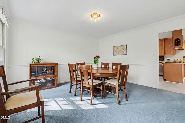 a dining room with furniture and a wooden floor