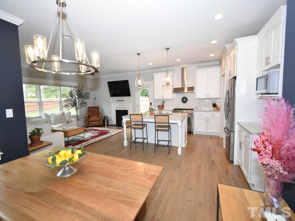 607 Morreene Road Durham, NC 27705 - Photo 11 of 48 a living room with stainless steel appliances kitchen island granite countertop furniture and a kitchen view