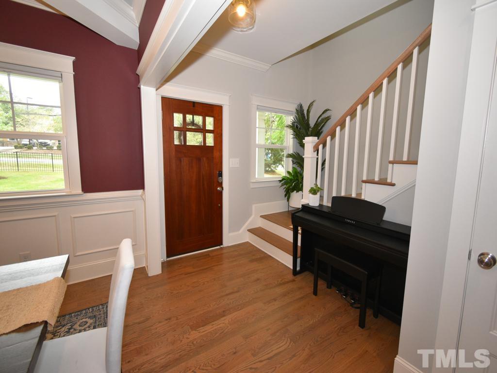 607 Morreene Road Durham, NC 27705 - Photo 15 of 48 a view of a hallway with wooden floor and a window