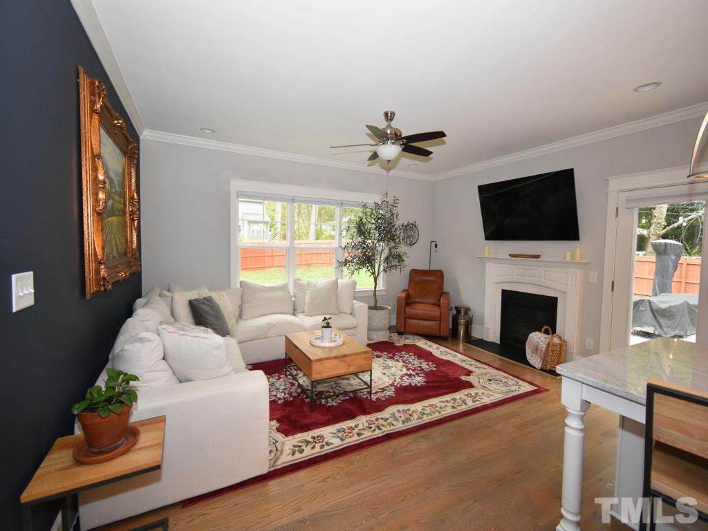 607 Morreene Road Durham, NC 27705 - Photo 16 of 48 a living room with furniture a fireplace and a flat screen tv