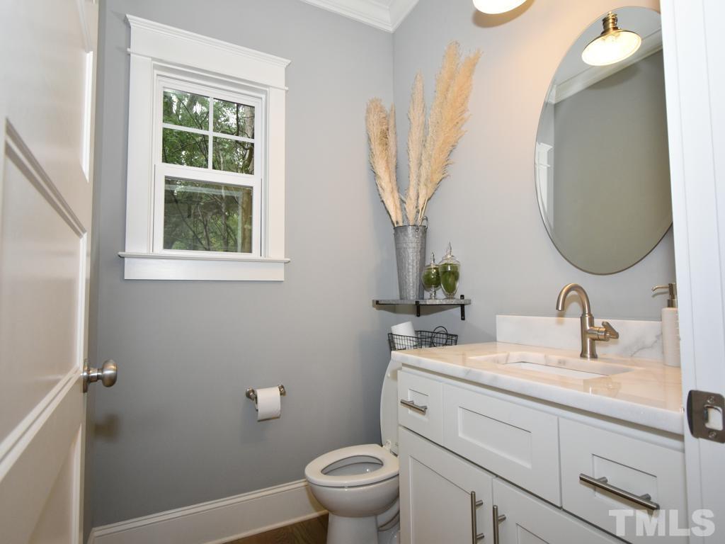 607 Morreene Road Durham, NC 27705 - Photo 19 of 48 a bathroom with a toilet sink and mirror