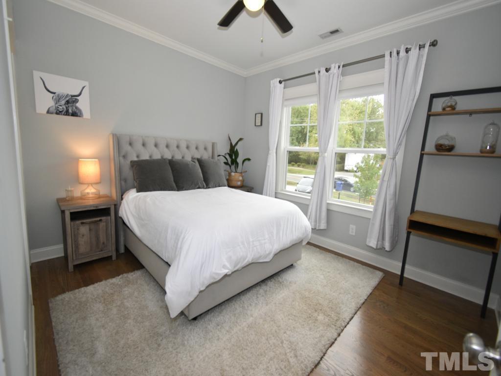 607 Morreene Road Durham, NC 27705 - Photo 22 of 48 a bedroom with a bed and a large window
