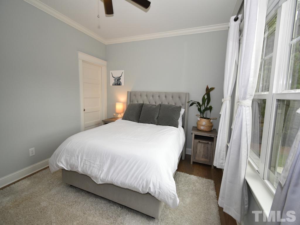 607 Morreene Road Durham, NC 27705 - Photo 23 of 48 a bed sitting in a bedroom next to a window