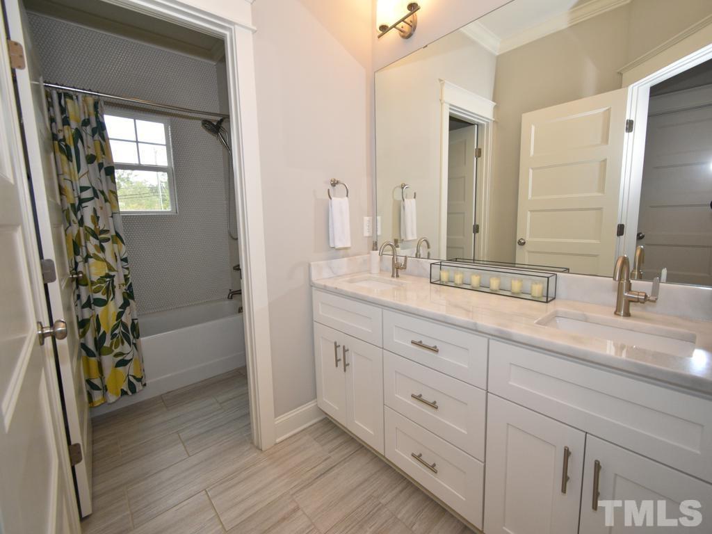 607 Morreene Road Durham, NC 27705 - Photo 25 of 48 a bathroom with a double vanity sink and a mirror