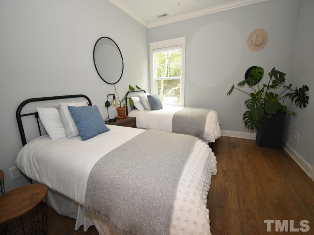 607 Morreene Road Durham, NC 27705 - Photo 27 of 48 a bed sitting in a bedroom next to a window