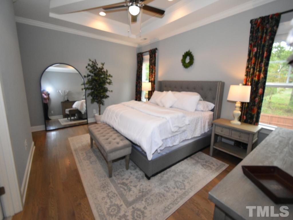 607 Morreene Road Durham, NC 27705 - Photo 31 of 48 a bedroom with a bed lamp and a fireplace