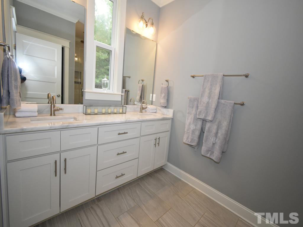 607 Morreene Road Durham, NC 27705 - Photo 32 of 48 a spacious bathroom with a double vanity sink mirror and
