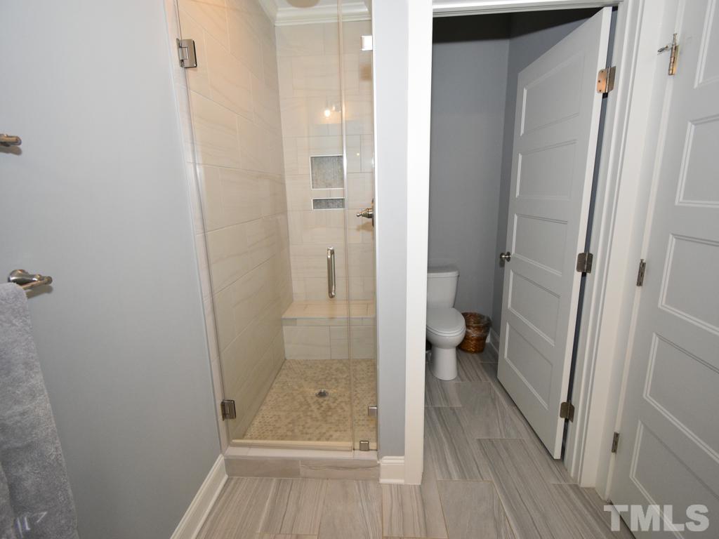 607 Morreene Road Durham, NC 27705 - Photo 36 of 48 a bathroom with a glass door shower