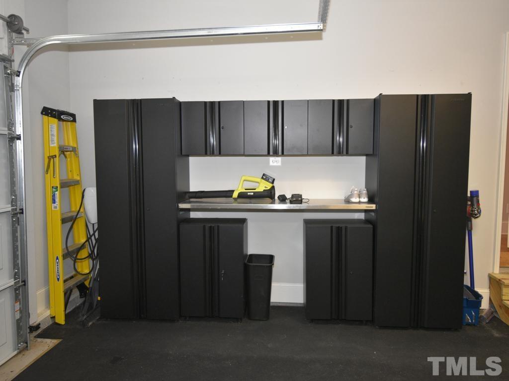 607 Morreene Road Durham, NC 27705 - Photo 37 of 48 a kitchen with a refrigerator and cabinets
