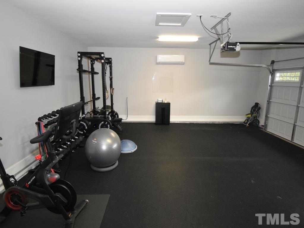 607 Morreene Road Durham, NC 27705 - Photo 38 of 48 a room with wooden floor and gym equipment