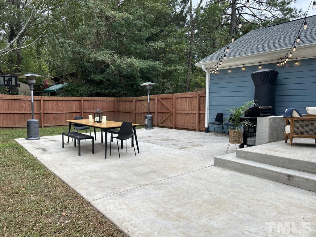 607 Morreene Road Durham, NC 27705 - Photo 42 of 48 a view of a patio with a table and chairs
