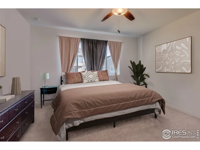 a bedroom with a large bed and a window