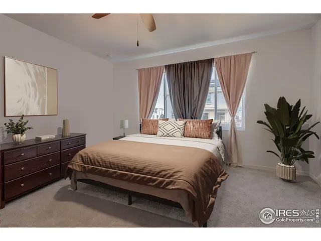 a bedroom with a bed and a potted plant