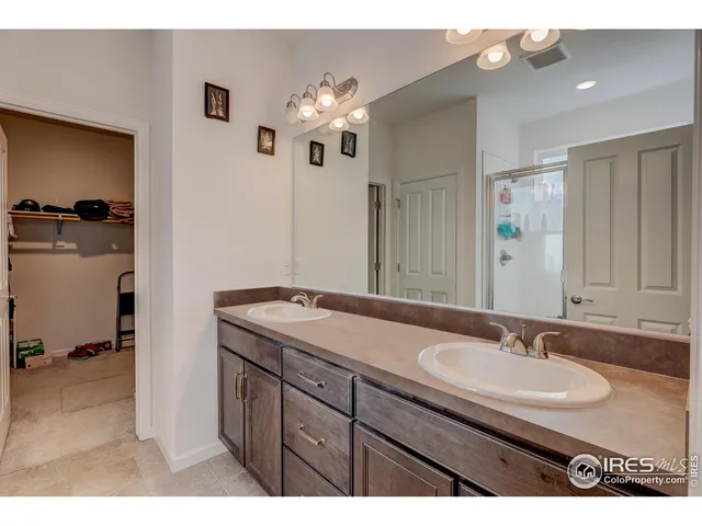 a bathroom with a sink double vanity and a mirror