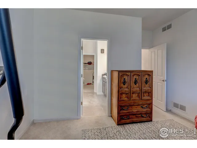 a view of wooden floor in a hall with an entryway