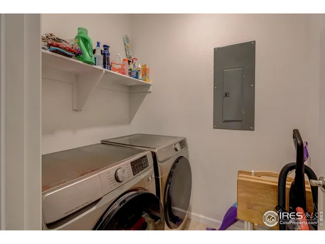 a living room with furniture a flat screen tv and a rug