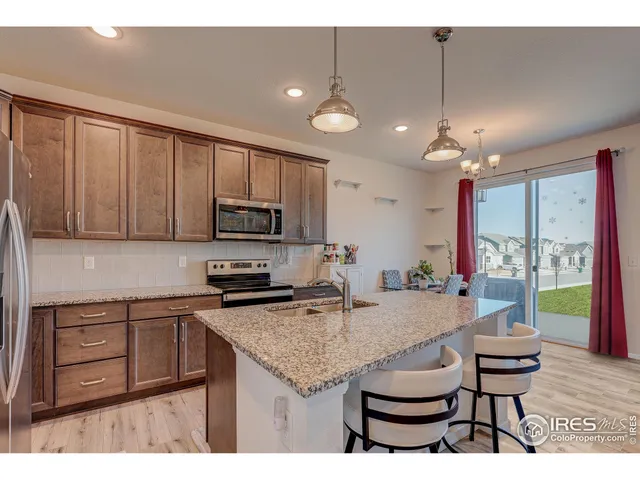 a kitchen with a stove a refrigerator and wooden cabinets