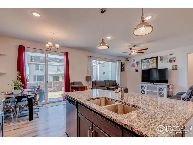 a kitchen with sink a counter and chairs