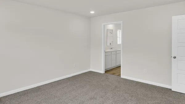 a view of an empty room and closet area