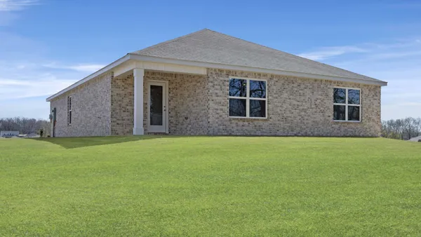 front view of a house with a garden