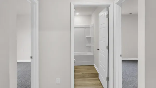 a view of a bathroom from a hallway