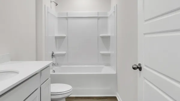 a bathroom with a bathtub a toilet and a sink