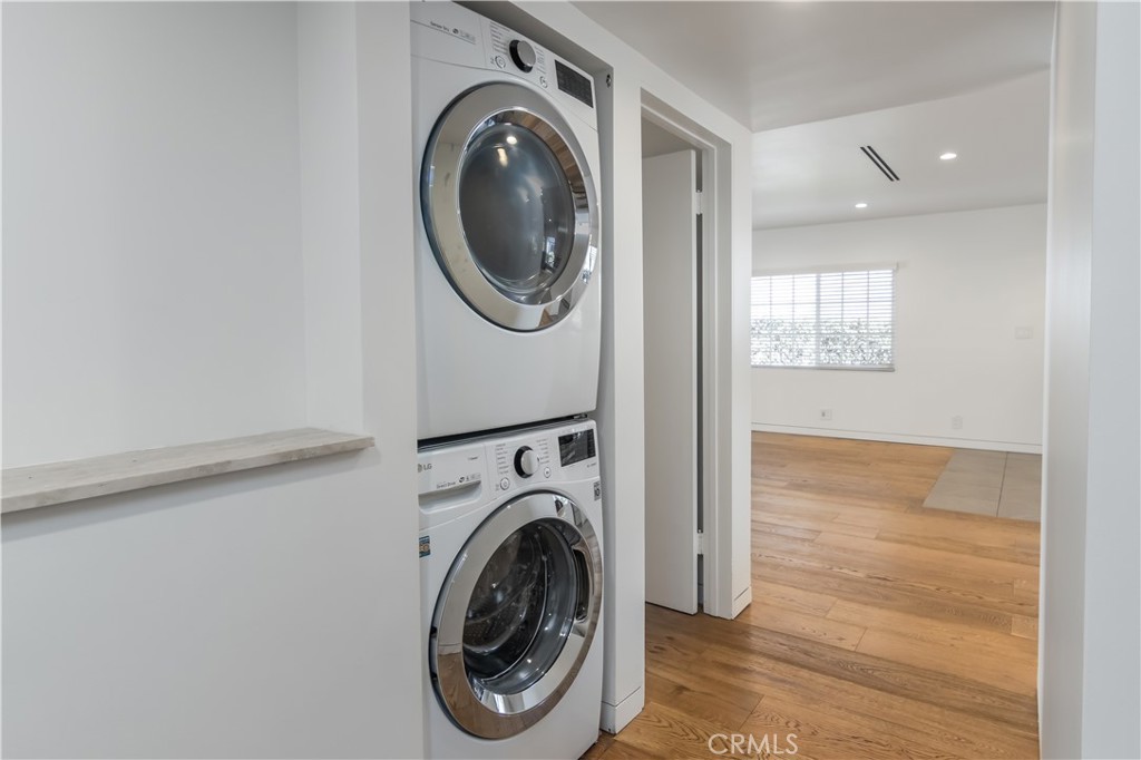 15439 Vose Street Van Nuys, CA 91406 - Photo 18 of 22 a view of a hallway with washer and dryer
