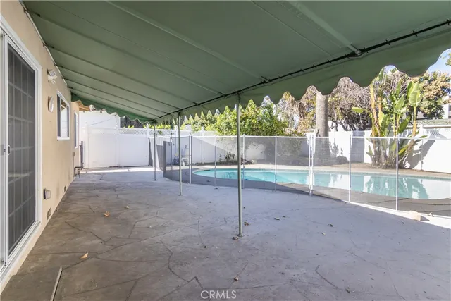 a view of a house with a swimming pool and a yard