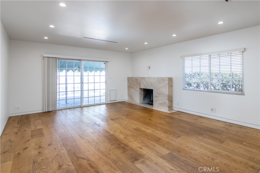 15439 Vose Street Van Nuys, CA 91406 - Photo 2 of 22 an empty room with windows and fireplace