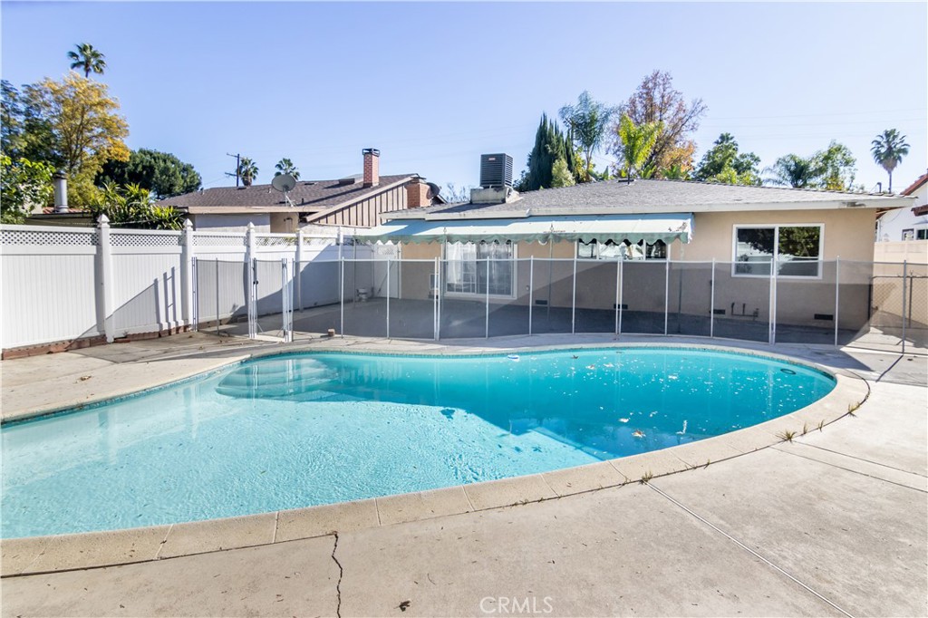 15439 Vose Street Van Nuys, CA 91406 - Photo 21 of 22 a view of a house with a swimming pool and a yard