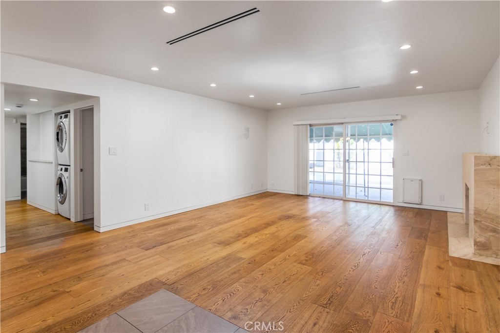 15439 Vose Street Van Nuys, CA 91406 - Photo 4 of 22 an empty room with wooden floor and windows