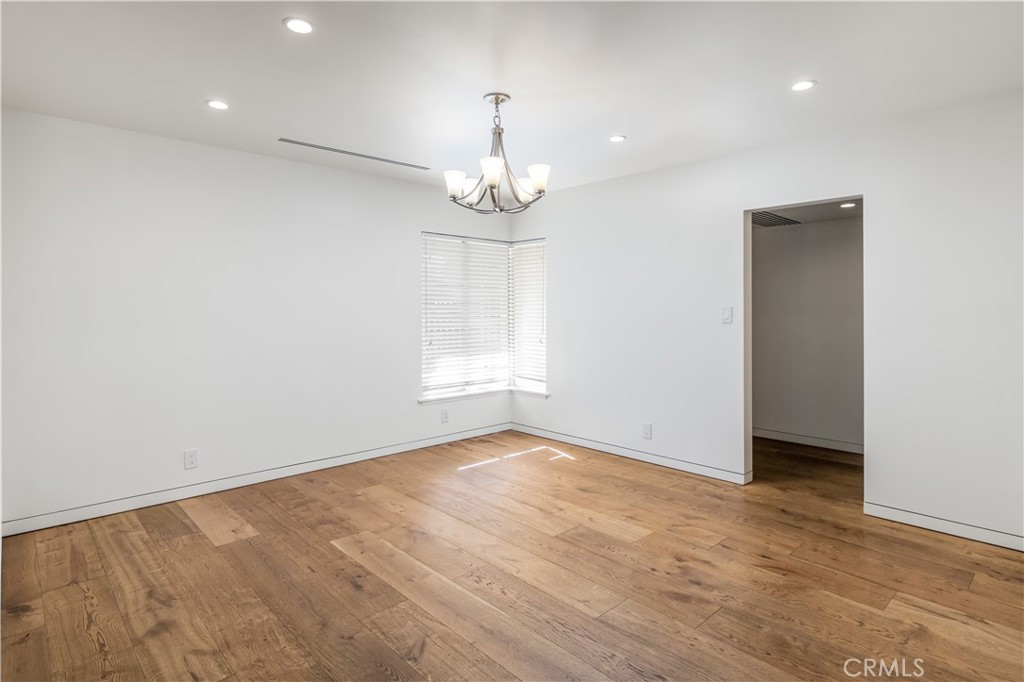 15439 Vose Street Van Nuys, CA 91406 - Photo 7 of 22 wooden floor in an empty room with a window