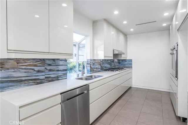 a kitchen with a sink stove and refrigerator