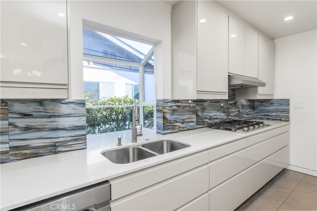 15439 Vose Street Van Nuys, CA 91406 - Photo 10 of 22 a kitchen with stainless steel appliances white cabinets and a sink