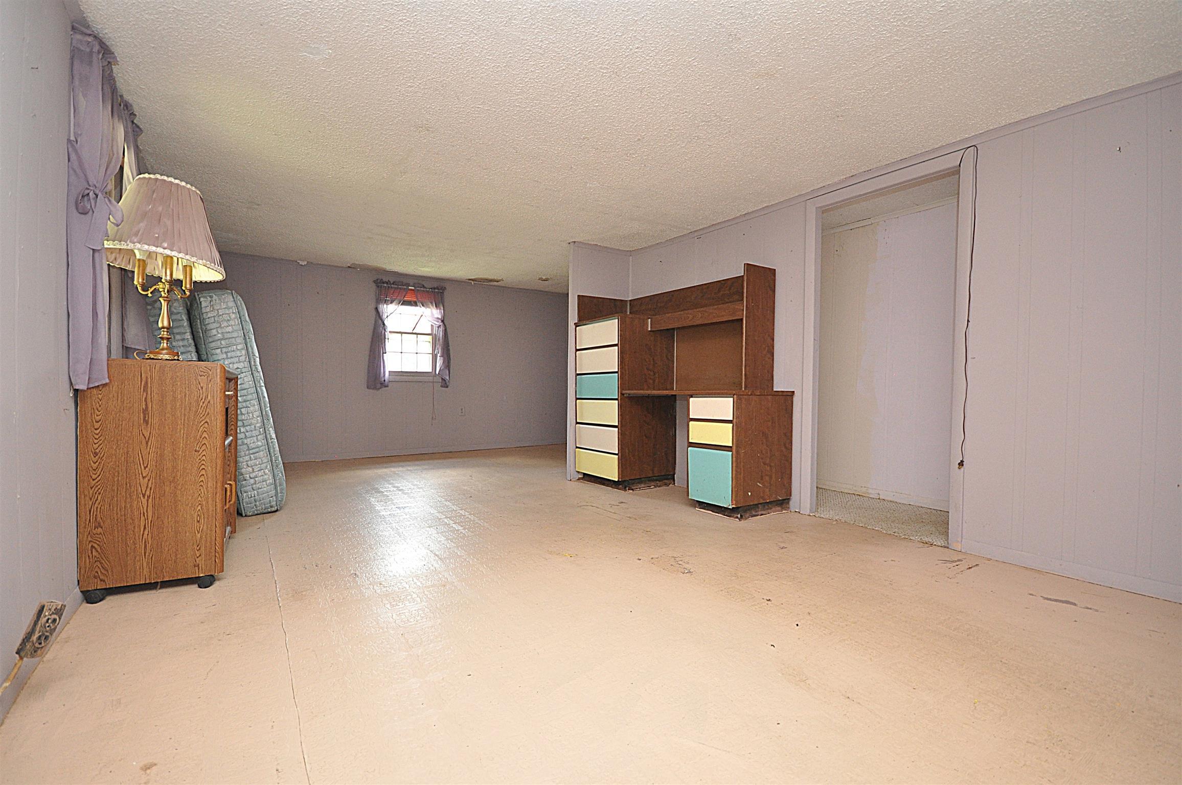 1536 Mack Bean Road Red Boiling Springs, TN 37150 - Photo 11 of 30 a view of an empty room with window and stairs