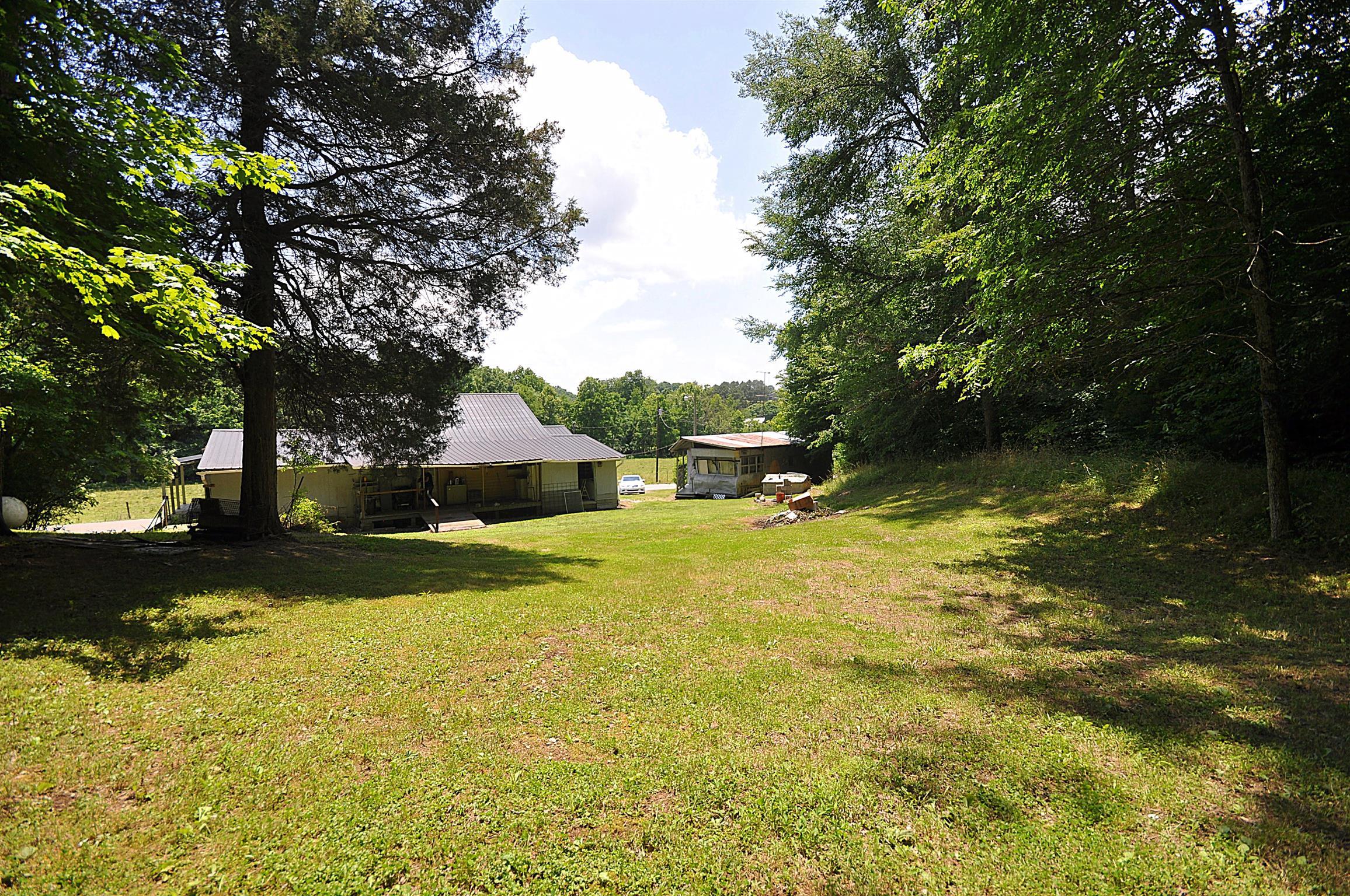 1536 Mack Bean Road Red Boiling Springs, TN 37150 - Photo 22 of 30 a view of a swimming pool and trees in the background