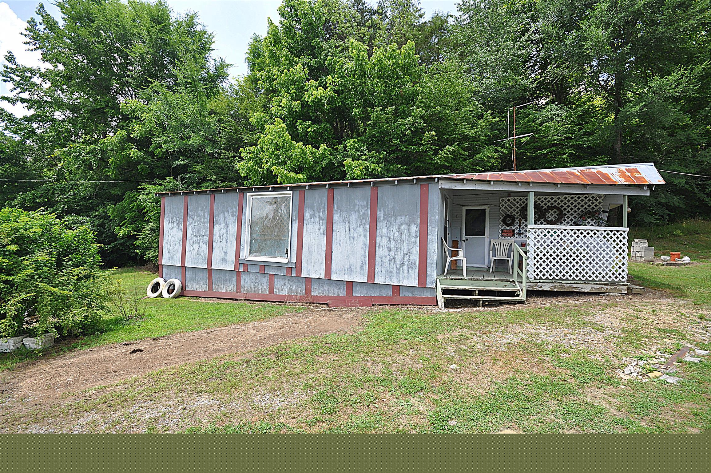 1536 Mack Bean Road Red Boiling Springs, TN 37150 - Photo 25 of 30 a backyard of a house with yard and outdoor seating