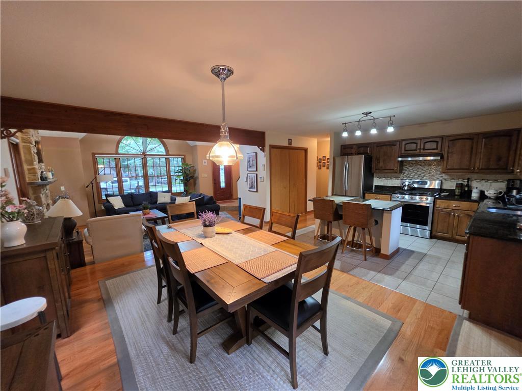 211 Murphy Circle Bushkill, PA 18324 - Photo 8 of 28 An open concept design seamlessly connects the dining area with a gourmet kitchen and inviting living space.