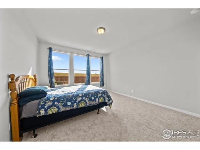 a bedroom with a bed and a lamp