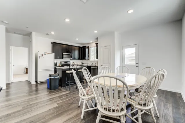 a kitchen with stainless steel appliances granite countertop a sink stove and cabinets